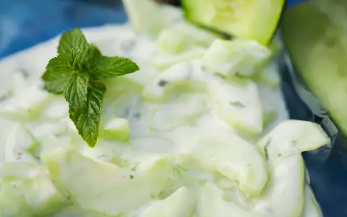 Cucumber and Yogurt Salad garnished with spearmint leaf